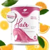 A product shot of a hair vitamin supplement can with surrounding orange slices and leaves. Produktbild-Vorschau