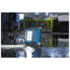A blue work light is sitting in the rain on a wet surface. Voir les images du produit