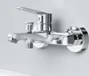 A close-up studio shot of a chrome bathtub faucet mounted on a light gray wall. Produktbild-Vorschau