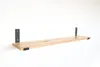 A wooden shelf with black metal brackets against a white background. Produktbild-Vorschau