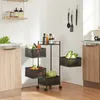 A kitchen scene with a rolling cart filled with fruits and vegetables, along with bottles of condiments on top. Produktbild-Vorschau
