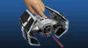 A LEGO model of a TIE Advanced fighter is being demonstrated by a hand, with a red laser beam effect. Podgląd zdjęcia produktu