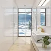 A modern bathroom with a shower cabin overlooking a snowy landscape. Produktbild-Vorschau