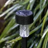 A solar garden light in the rain, surrounded by green foliage. Anteprima dell’immagine prodotto