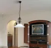 A pendant light hangs in a room with a TV cabinet and an arched doorway. Produktbild-Vorschau
