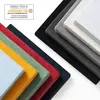 A diagonal arrangement of stacked fabric swatches in various colors, with a certification logo in the upper left corner. Voir les images du produit