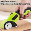 A hand is holding a green electric rotary cutter and is about to cut a piece of cardboard. Produktbild-Vorschau