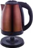 A copper-colored electric kettle and its base are shown against a white background. Voir les images du produit