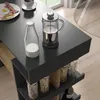 A breakfast setting on a dark countertop, with a French press, milk bottle, and a plate of food. Voir les images du produit