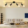 A modern living room with a sofa, coffee table, and a track light fixture on the ceiling. Voir les images du produit