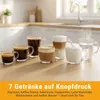 A collection of coffee and milk drinks in glass cups on a wooden surface, with a kitchen counter and window in the background. Produktbild-Vorschau