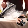 A person is holding a cordless steam iron over a fabric surface, with steam being emitted. A close-up inset shows a hand operating a control on the iron. Produktbild-Vorschau