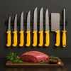 A set of 10 professional knives with yellow handles displayed on a magnetic strip, with a raw cut of meat and herbs on a wooden board in the foreground. Produktbild-Vorschau
