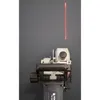A laser cutting tool is shown against a gray wall, projecting a red laser line. Náhľad obrázku produktu
