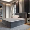 A bedroom scene featuring a large boxspring bed. Produktbild-Vorschau