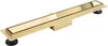 A linear shower drain with a gold finish, shown from a diagonal angle against a white background. Podgląd zdjęcia produktu