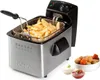 A deep fryer filled with french fries, with bowls of dipping sauces and fried snacks nearby. Produktbild-Vorschau