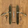 Door handles and hardware laid out on a wooden surface. Produktbild-Vorschau