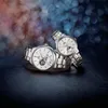 Two Orient Sun and Moon automatic watches are displayed on a dark, textured surface with a bokeh background. Produktbild-Vorschau