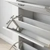 Close-up view of a white shoe cabinet with open drawers, showing internal dimensions. Produktbild-Vorschau