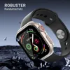 A smartwatch with a protective case is shown against a dark, rocky background with a gradient sky. Produktbild-Vorschau