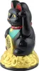 A black Maneki-neko (lucky cat) figurine sits on a pile of gold ingots. Produktbild-Vorschau