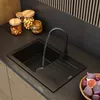 A modern kitchen sink with water running from the faucet, surrounded by kitchen items. Náhľad obrázku produktu