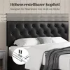 A black upholstered headboard with tufted buttons, shown on a bed with white bedding and a grey throw blanket. Measurement indicators are shown on the left side. Produktbild-Vorschau