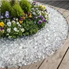 Transparente Glaskristalle als runde Umrandung eines Blumenbeets neben Holzdielen Produktbild-Vorschau