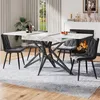 A dining room scene with a marble-look extendable dining table and chairs, set near a fireplace. Produktbild-Vorschau