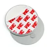 A close-up, overhead view of two round metal discs, one on top of the other, against a white background. The top disc has a peel-back adhesive backing with the 3M logo repeated multiple times in red and white. A small, circular magnet is visible on the bot Anteprima dell’immagine prodotto