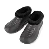 A pair of black winter clogs with black fur lining, shown against a white background. Produktbild-Vorschau