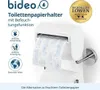 A white toilet paper holder with a roll of toilet paper, featuring a blue patterned design, mounted on a wall. The image includes marketing text and icons. Produktbild-Vorschau