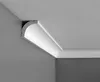 A corner of a room showing white crown molding installed on the ceiling and wall. Náhľad obrázku produktu