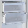 Close-up view of the interior of a refrigerator or freezer, showing two clear drawers with symbols on them. Voir les images du produit