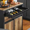 A close-up view of a kitchen island with a wine rack drawer extended, showing several bottles of wine. Produktbild-Vorschau