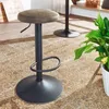 A bar stool is shown in a room with a patterned rug and a plant. Produktbild-Vorschau