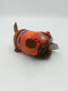 A plush toy dog wearing an orange and blue life vest, lying on a white background. Podgląd zdjęcia produktu