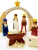 A wooden nativity scene with figures and a manger. Produktbild-Vorschau