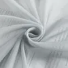 A close-up shot of a light gray sheer fabric with a faint newspaper print pattern visible underneath. Produktbild-Vorschau