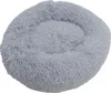 A fluffy, round, gray pet bed is shown against a white background. Produktbild-Vorschau