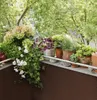 A balcony filled with various potted plants, creating a lush and green atmosphere. Produktbild-Vorschau