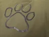 A close-up of a green fabric with a paw print logo. Anteprima dell’immagine prodotto