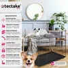 A dog crate is shown in a living room setting with decorative elements and plants. Produktbild-Vorschau