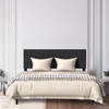 A bed with a black headboard and cream bedding is shown in a room with white paneled walls. Náhled obrázku produktu
