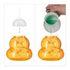 Two images showing the process of filling a wasp trap. The left image shows a clear plastic lid being placed onto an orange wasp trap. The right image shows green liquid being poured from a white pitcher into the orange wasp trap. Produktbild-Vorschau