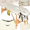 A collage of images showing a massage table and its accessories, including a carrying case and headrest. Náhled obrázku produktu
