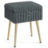 A gray upholstered stool with gold metal legs on a white background. Produktbild-Vorschau