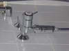 A close-up shot of a chrome shower filter attached to a faucet, set against a tiled background. Náhľad obrázku produktu
