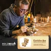 A woodcarver working on a small wooden animal figure. Produktbild-Vorschau